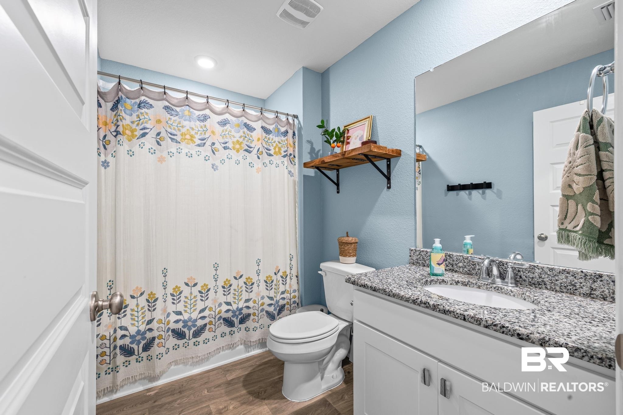 3078 Camino Real Loop Lillian, AL 36549 - Photo 20 of 51 Bathroom featuring vanity, dark wood-type flooring, and shower / tub combo with curtain
