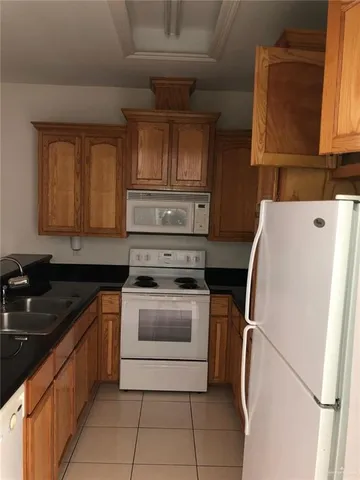 a kitchen with a sink a stove and a refrigerator