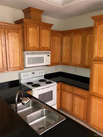 a kitchen with a sink cabinets and a window