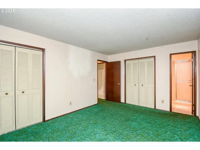 a bathroom with a toilet sink a mirror and shower