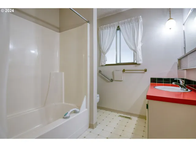 a view of a backyard with ocean and mountain view