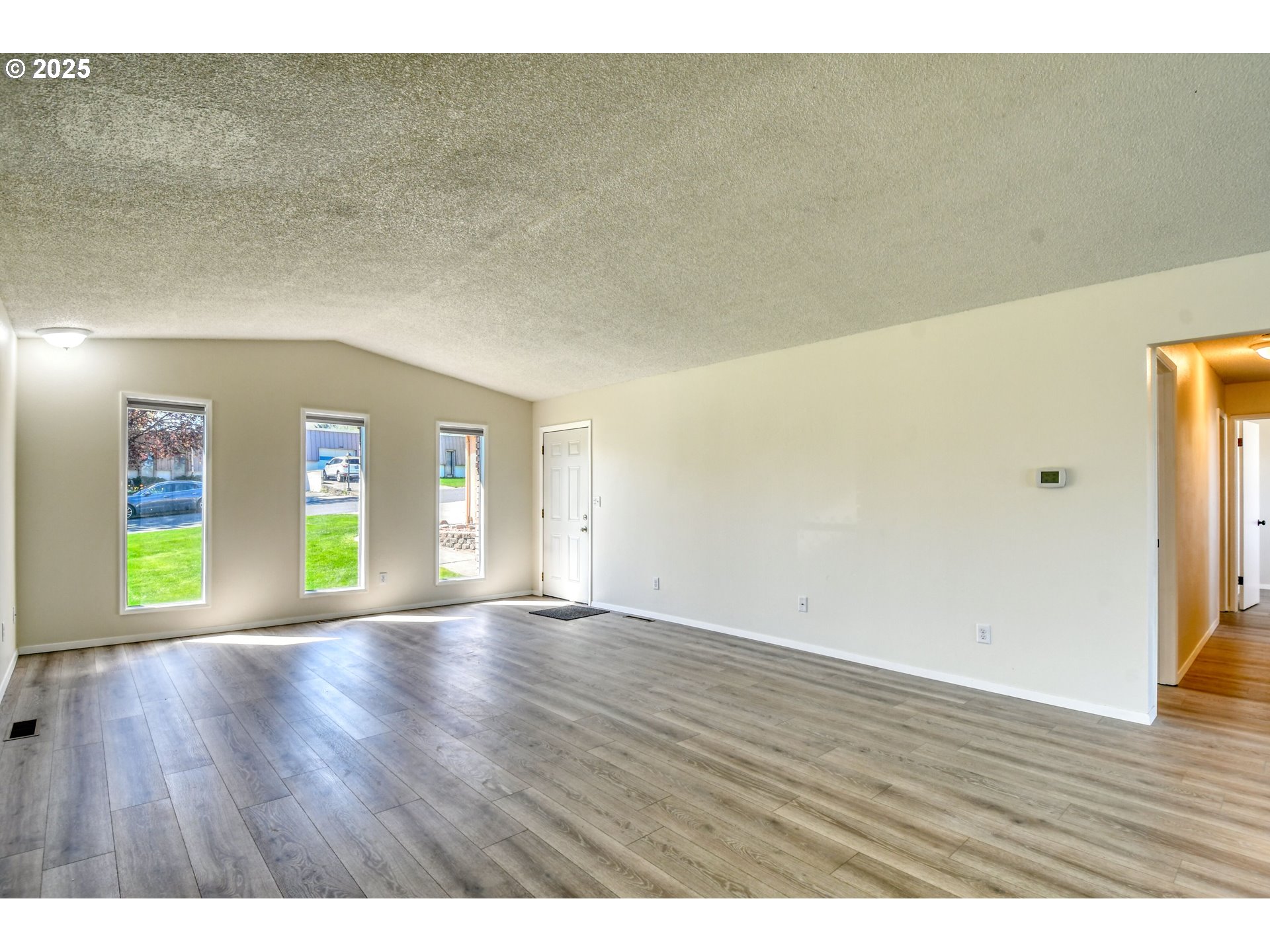 1209 Zeta Court Pendleton, OR 97801 - Photo 28 of 48 a view of an empty room with window and wooden floor