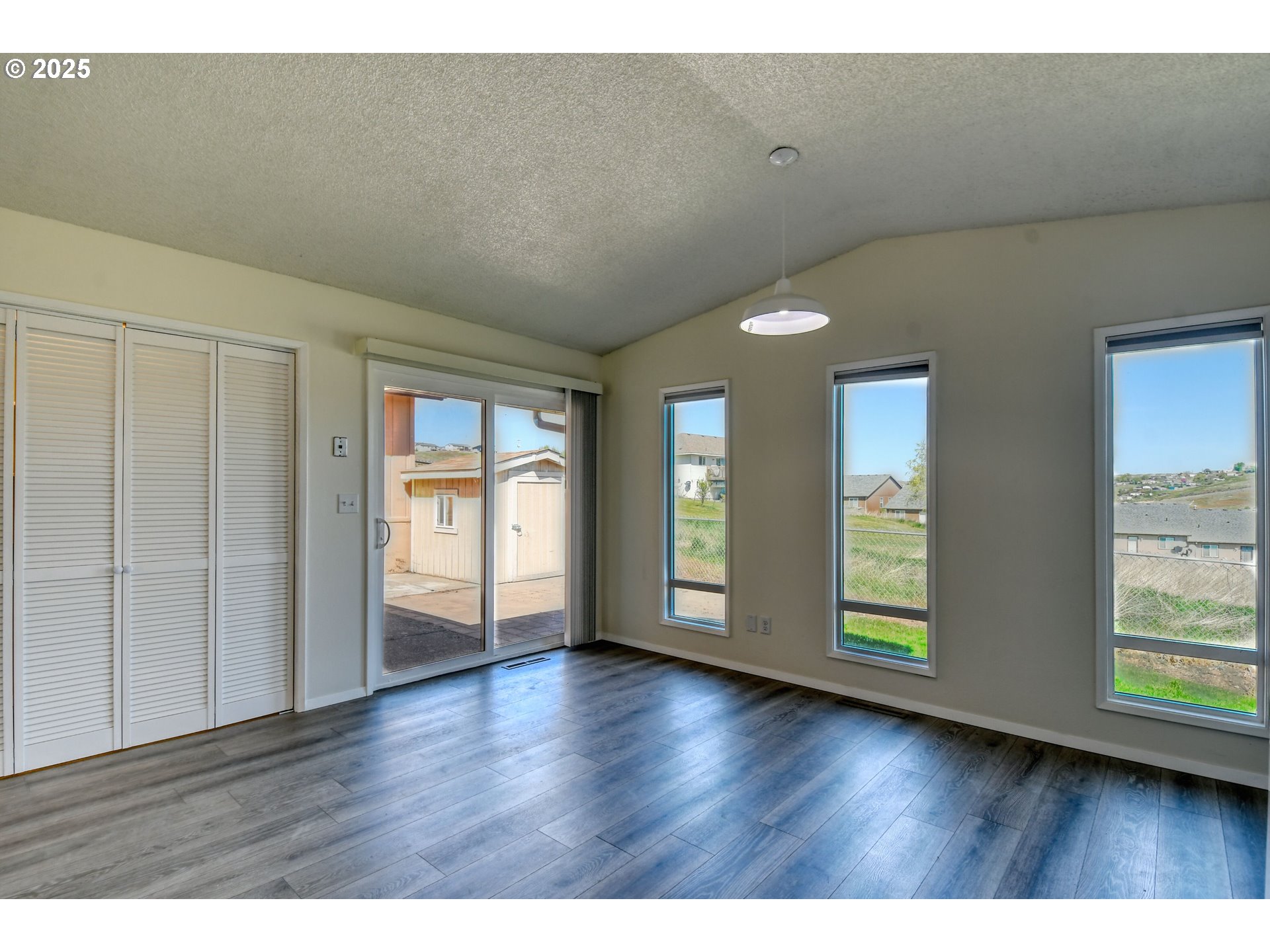 1209 Zeta Court Pendleton, OR 97801 - Photo 34 of 48 a view of an empty room with wooden floor and windows