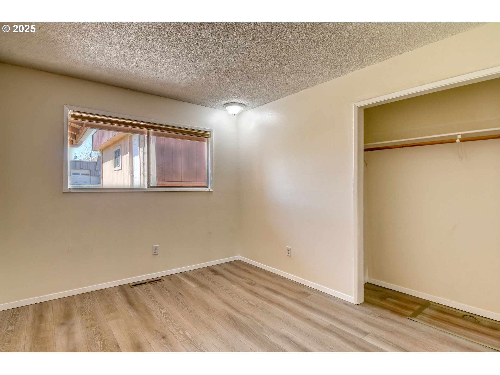 1209 Zeta Court Pendleton, OR 97801 - Photo 36 of 48 a view of an empty room with wooden floor and a window
