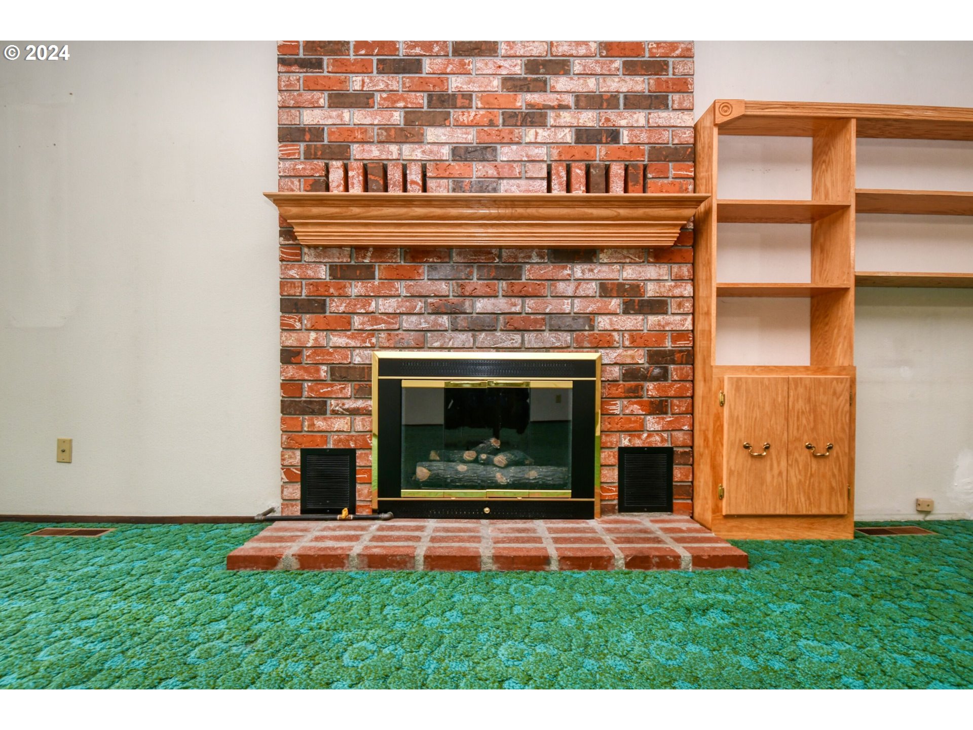 1209 Zeta Court Pendleton, OR 97801 - Photo 7 of 48 a living room with a fireplace and a flat screen tv