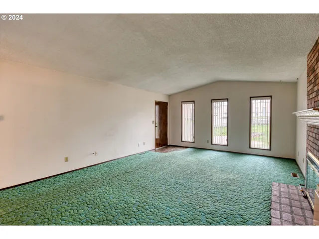 a kitchen with stainless steel appliances kitchen island granite countertop a refrigerator a stove and a sink