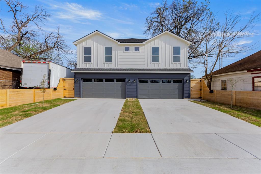 3524 Spring Avenue Dallas, TX 75210 - Photo 1 of 29 View of front of home featuring board and batten siding, concrete driveway, an attached garage, and a gate