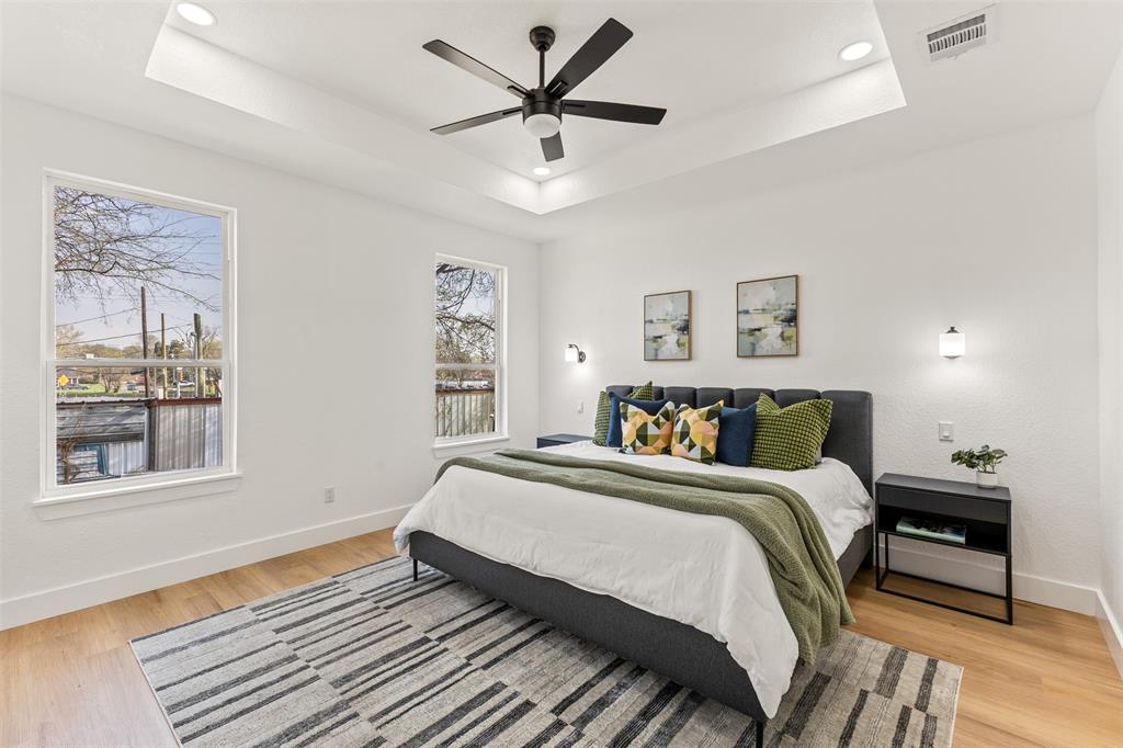 3524 Spring Avenue Dallas, TX 75210 - Photo 17 of 29 Bedroom featuring light wood finished floors, a ceiling fan, recessed lighting, and a tray ceiling