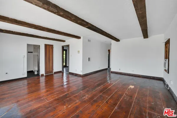 a view of room with window and hardwood floor