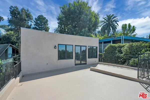 a view of a door and chair in backyard of the house