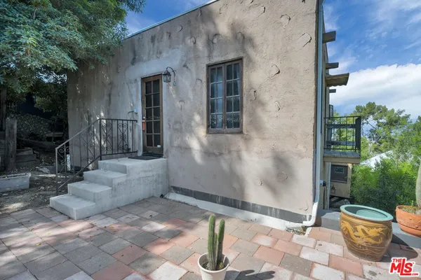 an aerial view of a house with a garden and a sitting area