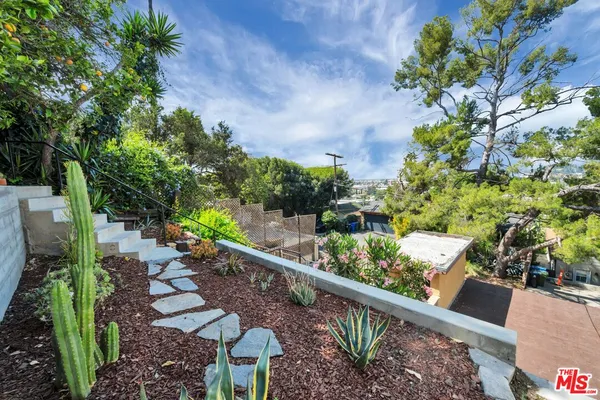 an aerial view of residential building and trees around