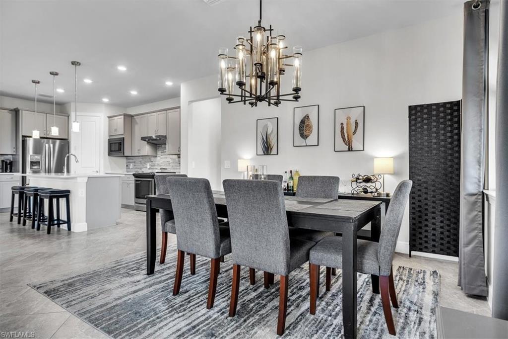 3032 Walnut Grove Lane Alva, FL 33920 - Photo 14 of 49 a view of a dining room with furniture and chandelier