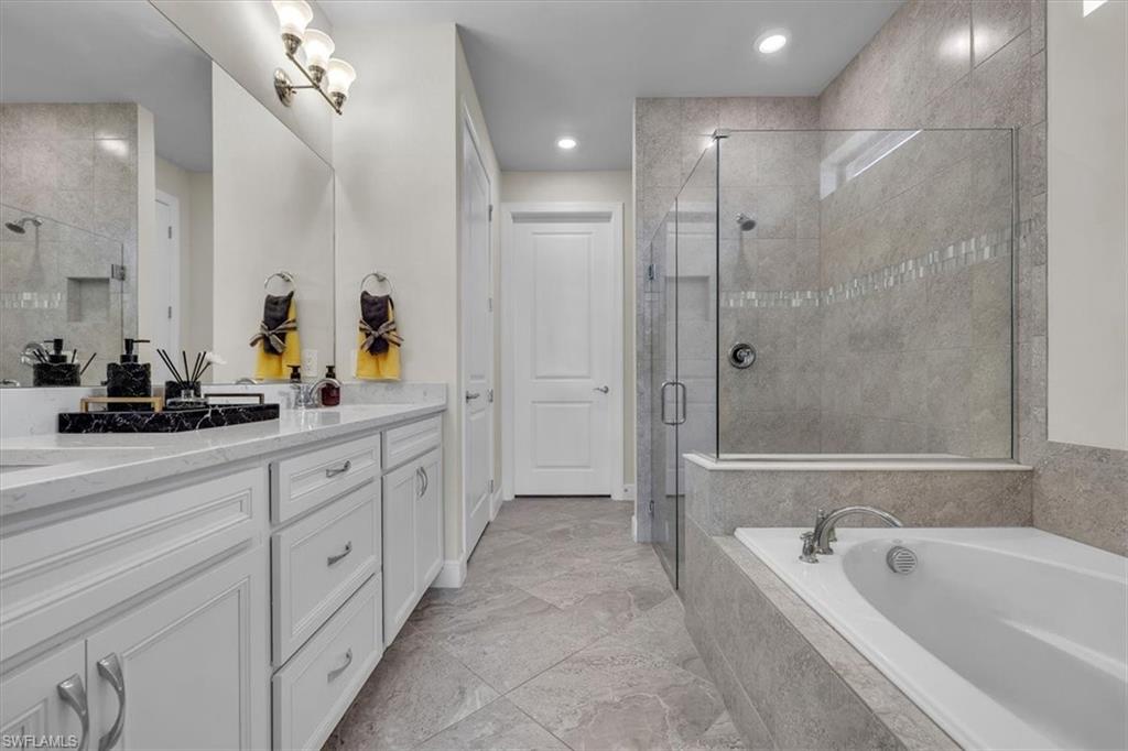 3032 Walnut Grove Lane Alva, FL 33920 - Photo 23 of 49 a spacious bathroom with a tub sink shower and mirror