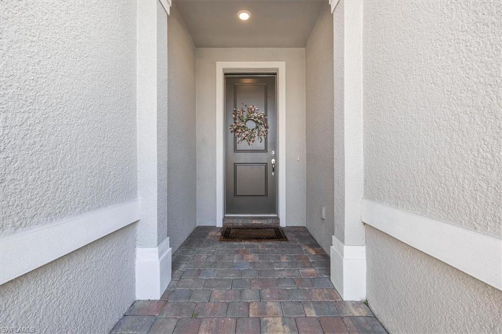 3032 Walnut Grove Lane Alva, FL 33920 - Photo 5 of 49 a view of a hallway with a glass door and a bathroom
