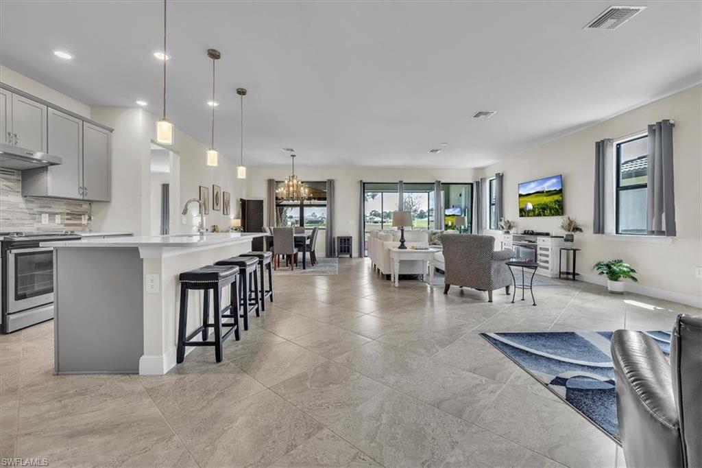 3032 Walnut Grove Lane Alva, FL 33920 - Photo 8 of 49 a large kitchen with a table and chairs in it