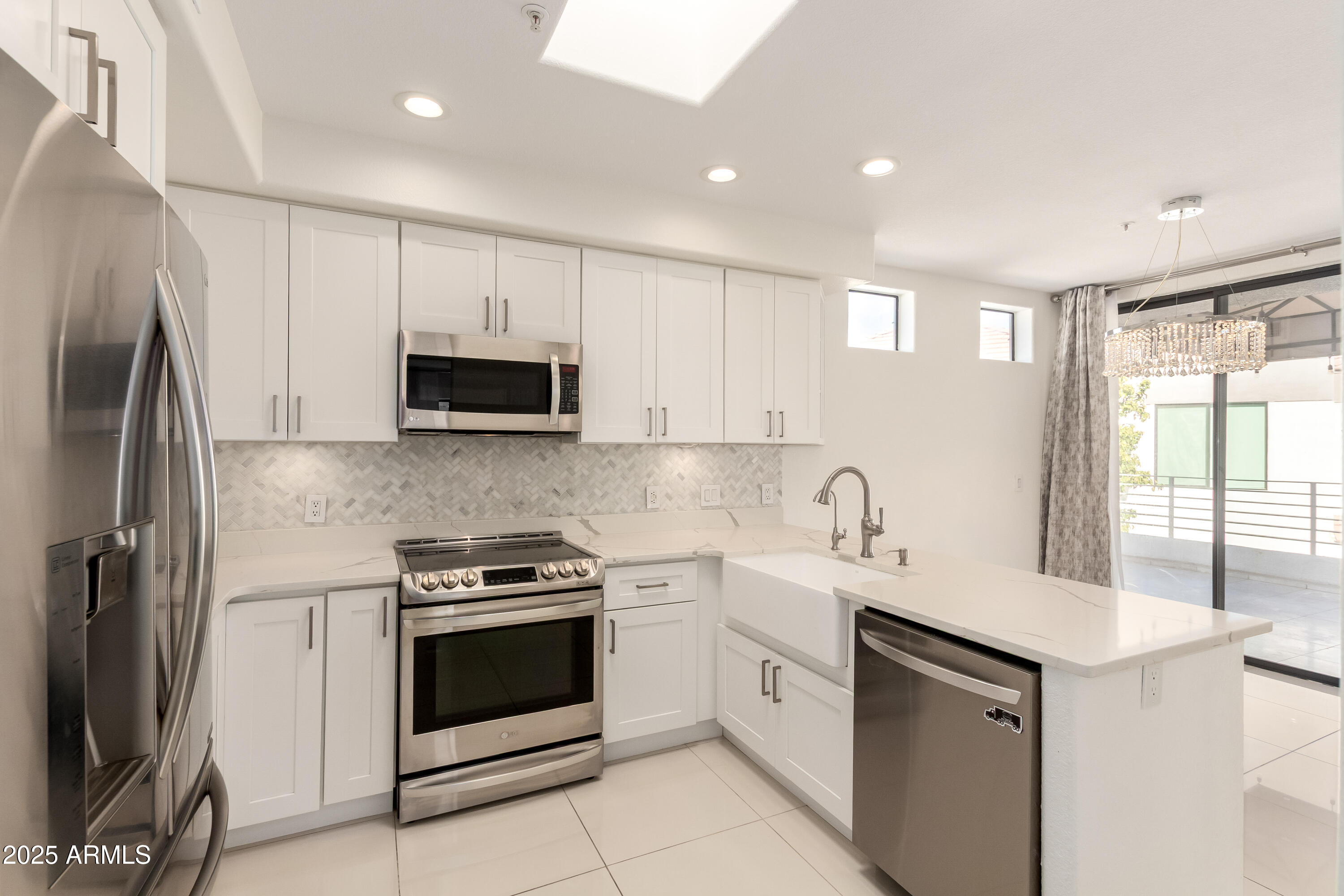 7222 East Gainey Ranch Road Scottsdale, AZ 85258 - Photo 2 of 13 a kitchen with a sink stove and microwave