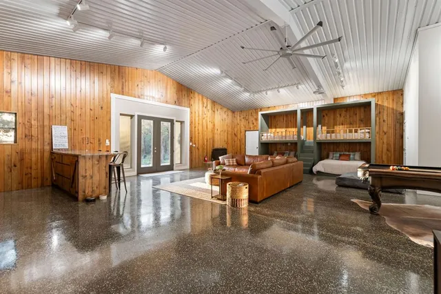 a living room with lots of furniture and a chandelier