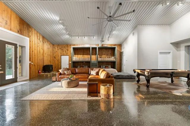 a room with pool table and windows