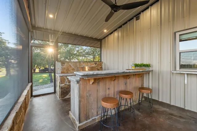 a view of a living room and a kitchen with a sink