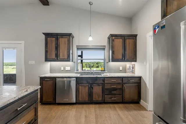a kitchen with stainless steel appliances granite countertop a stove and a sink
