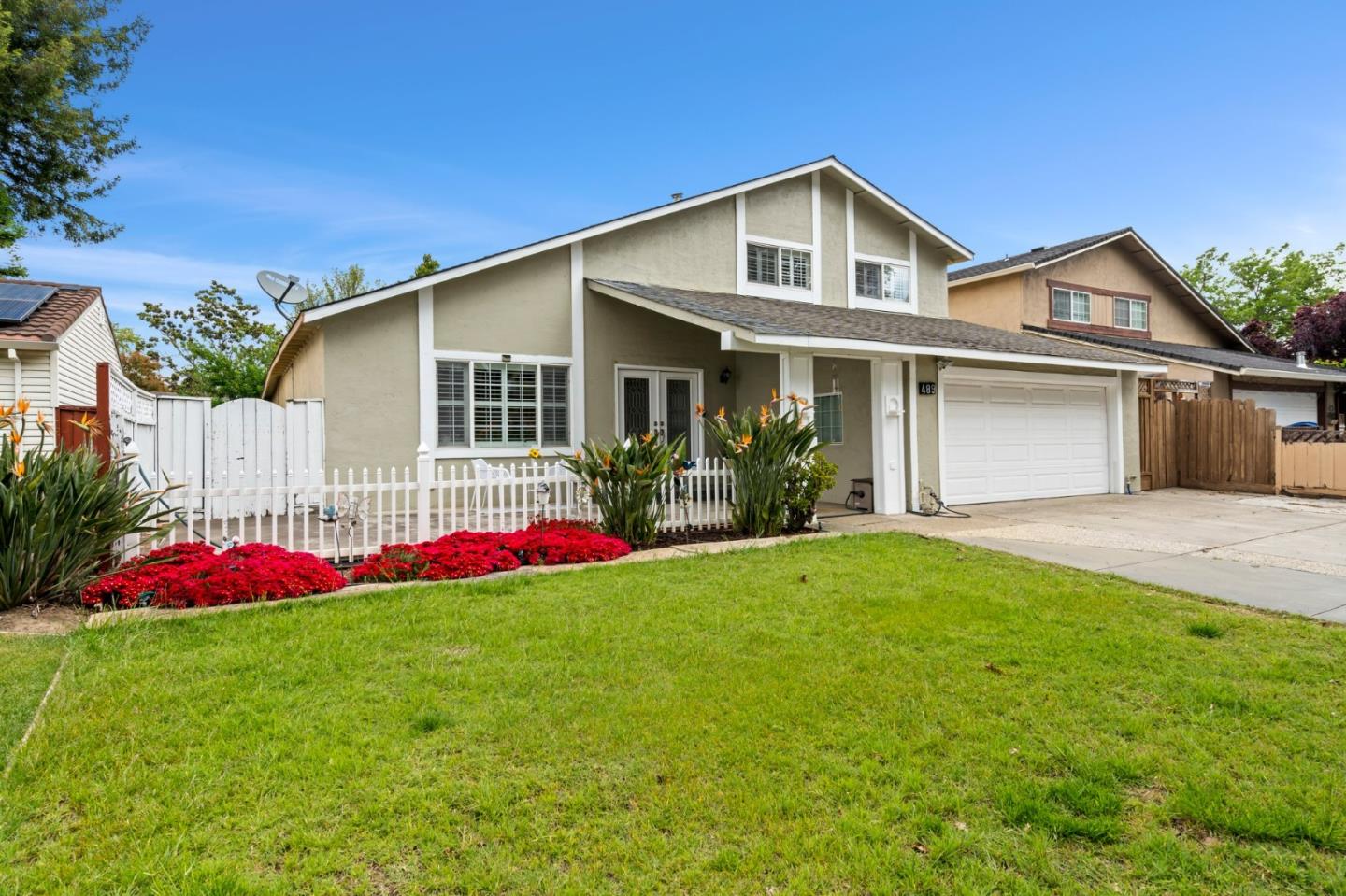 a front view of a house with yard and porch