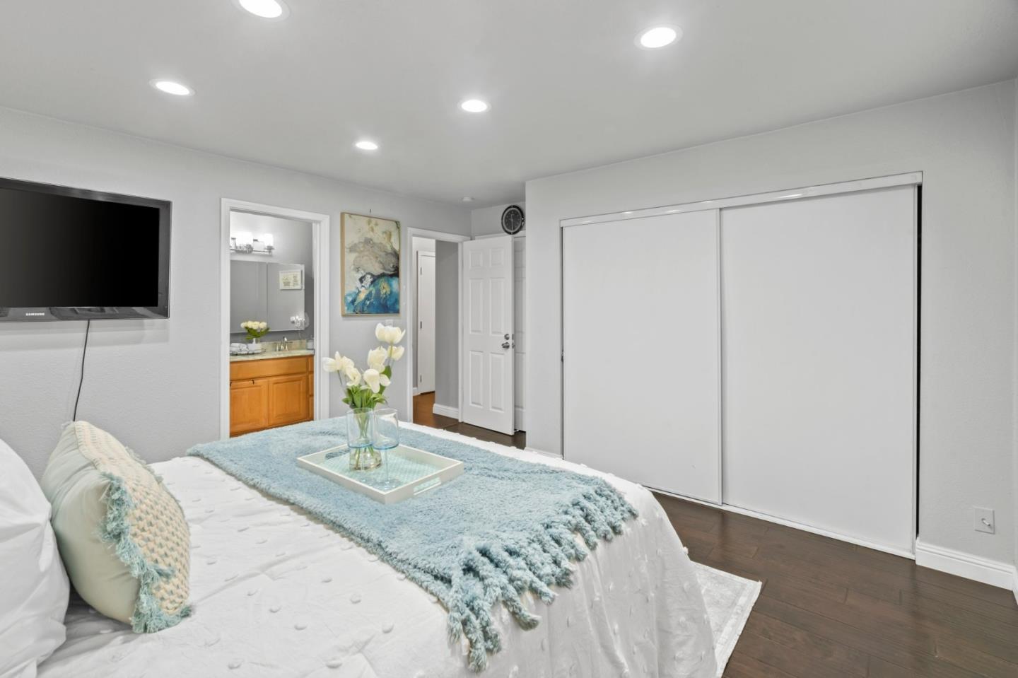 489 Hassinger Road San Jose, CA 95111 - Photo 27 of 41 a bedroom with a large bed and a flat screen tv