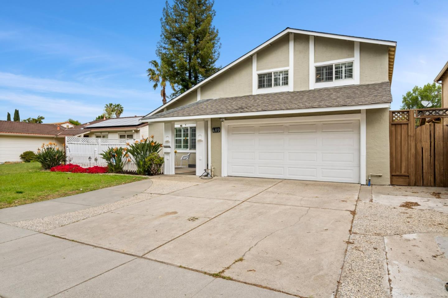 489 Hassinger Road San Jose, CA 95111 - Photo 3 of 41 a front view of a house with a yard and garage