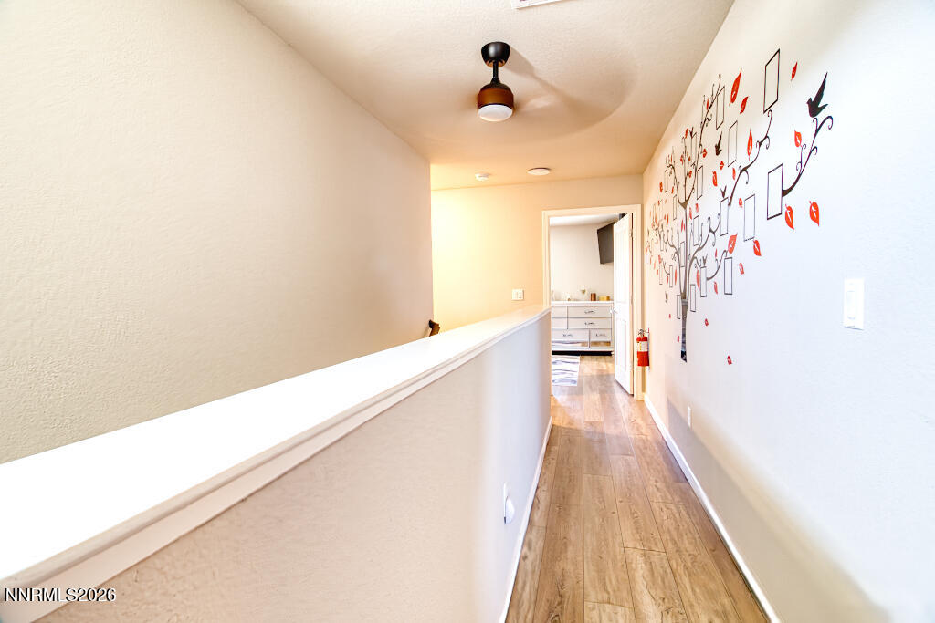 8957 Buffalo Grove Drive Reno, NV 89506 - Photo 40 of 59 a view of a hallway with wooden floor and staircase