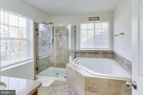 a bath tub sitting in a bathroom next to a window