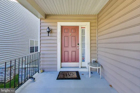 a view of a house with a door and wooden walls