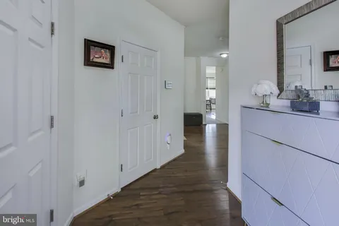 a hallway with a sink and a mirror