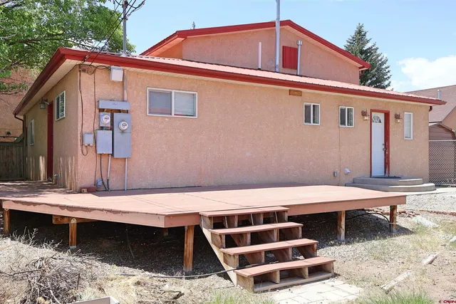 a view of a hallway with wooden floor and stairs