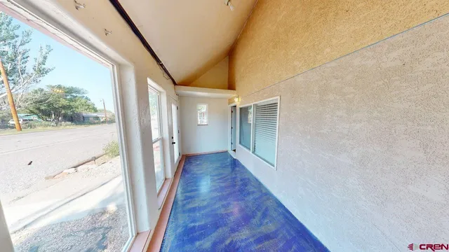 a view of a room with wooden floor and window