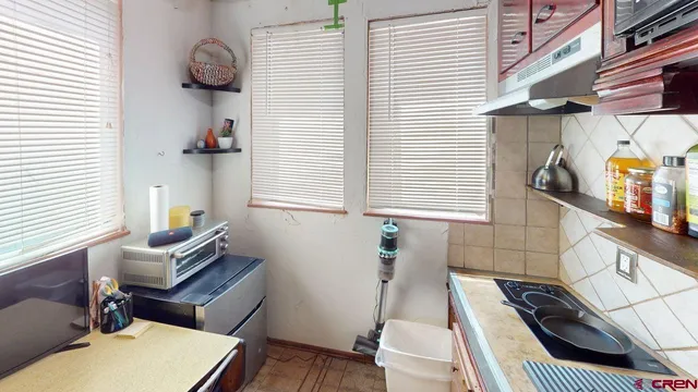a view of a livingroom with furniture and staircase