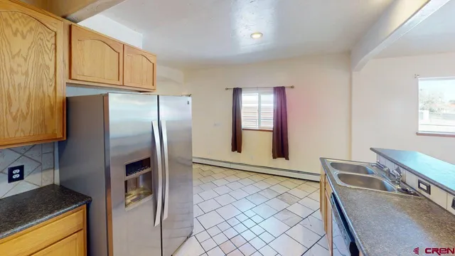 a kitchen with stainless steel appliances granite countertop a refrigerator a stove and a sink with granite countertops