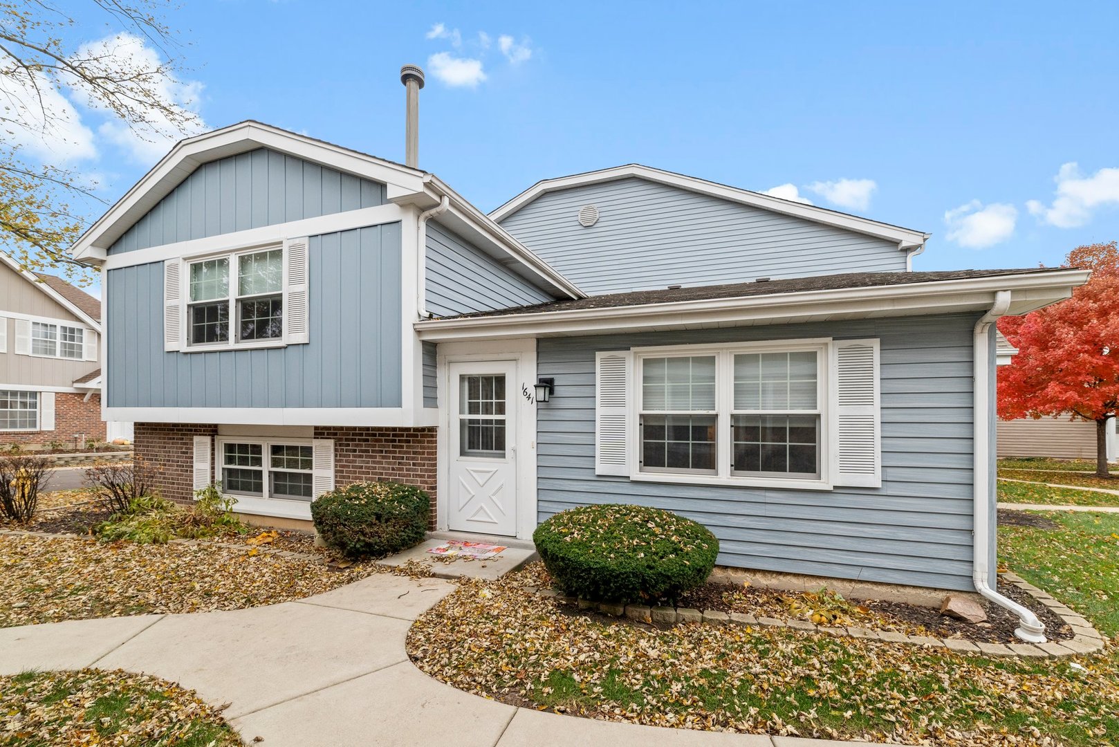 a view of a house with a yard and plants