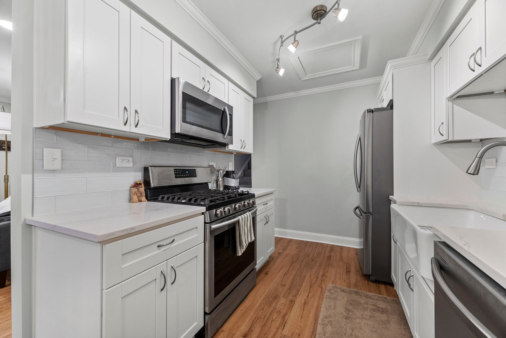 1641 Timber Trail, Unit A Wheaton, IL 60189 - Photo 6 of 16 a kitchen with stainless steel appliances white cabinets and a stove top oven