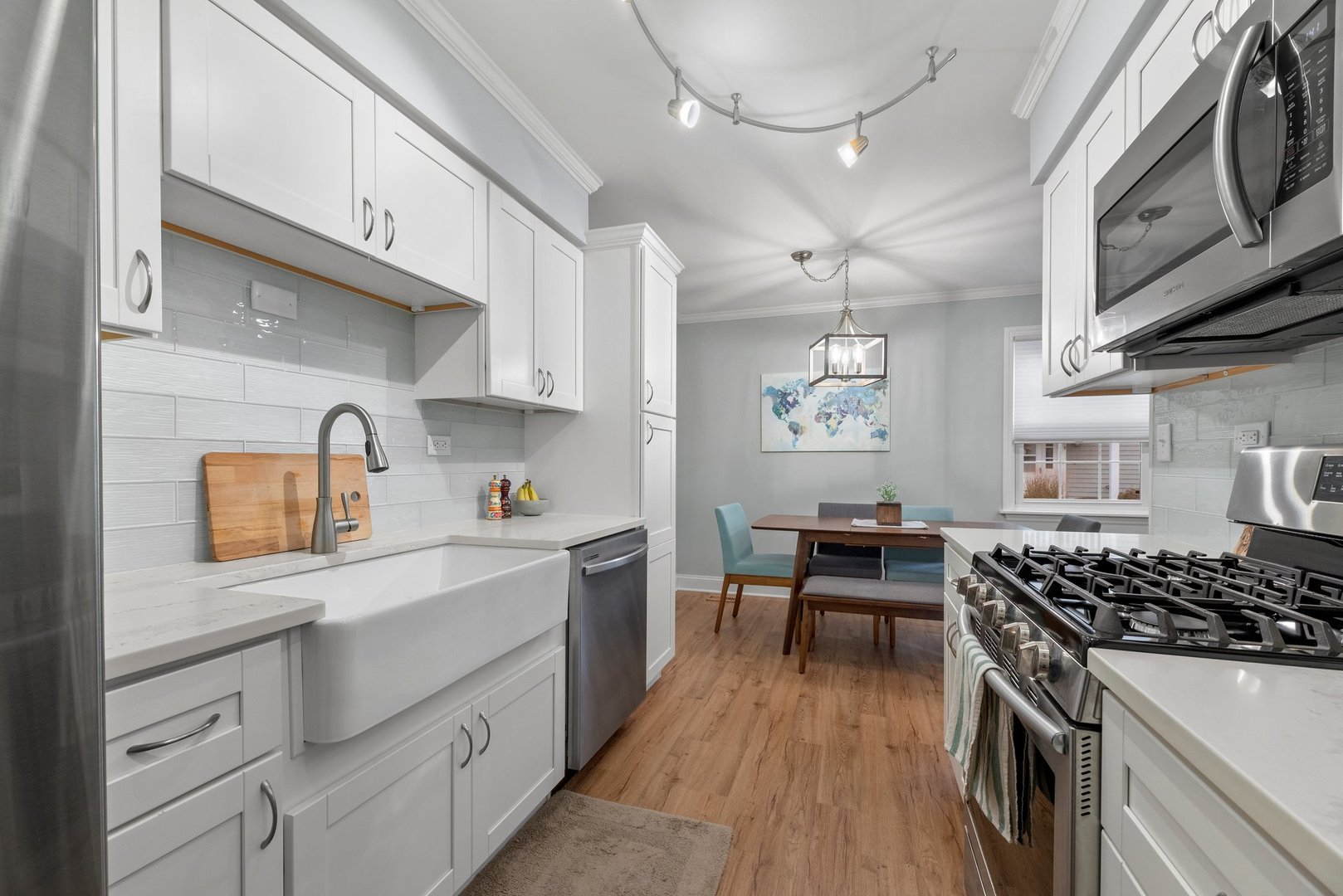 1641 Timber Trail, Unit A Wheaton, IL 60189 - Photo 7 of 16 a kitchen with stainless steel appliances a stove a sink dishwasher and white cabinets with wooden floor