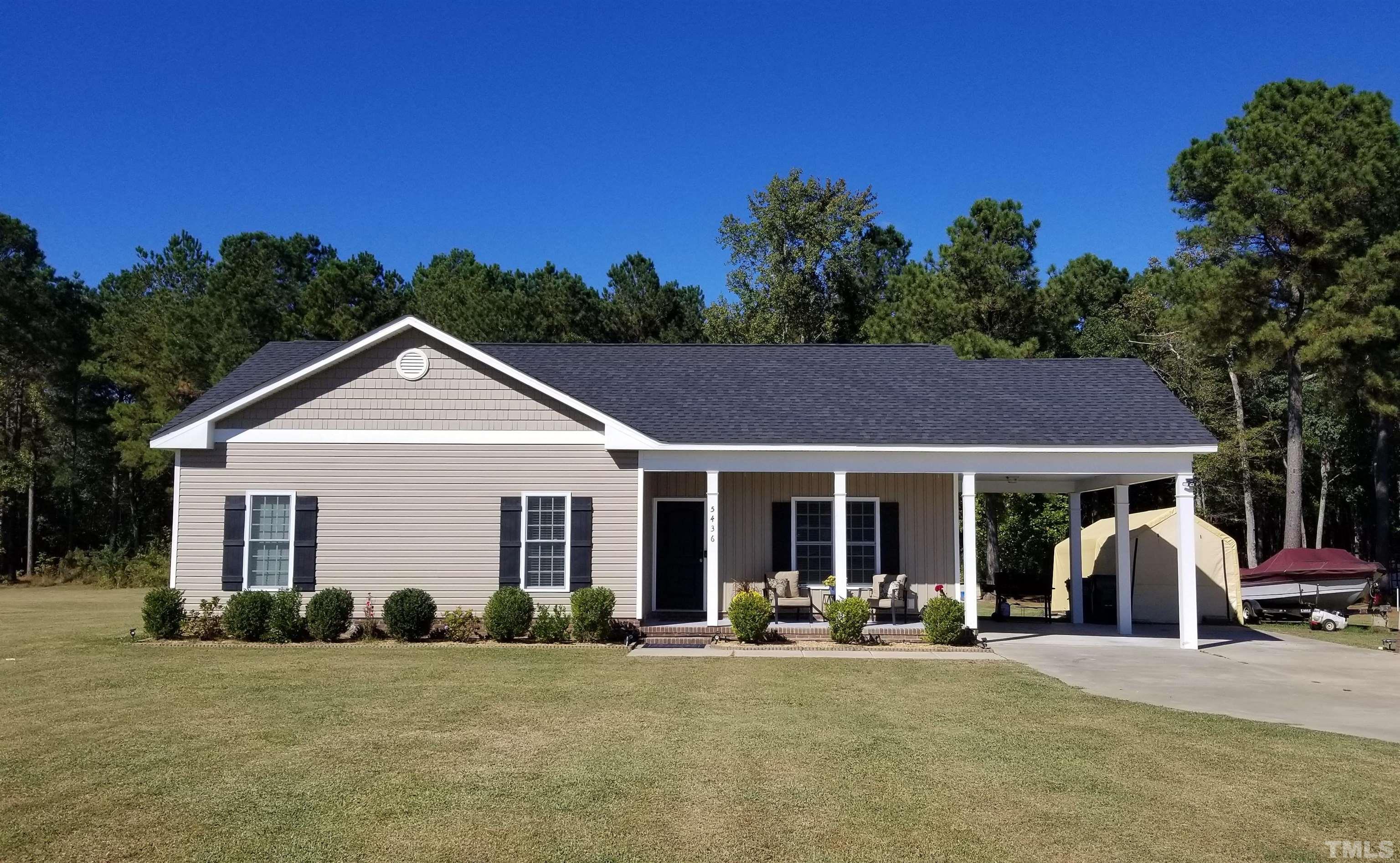 5436 Shepherd Road Wilson, NC 27893 - Photo 1 of 28 a view of a white house with large windows and palm trees