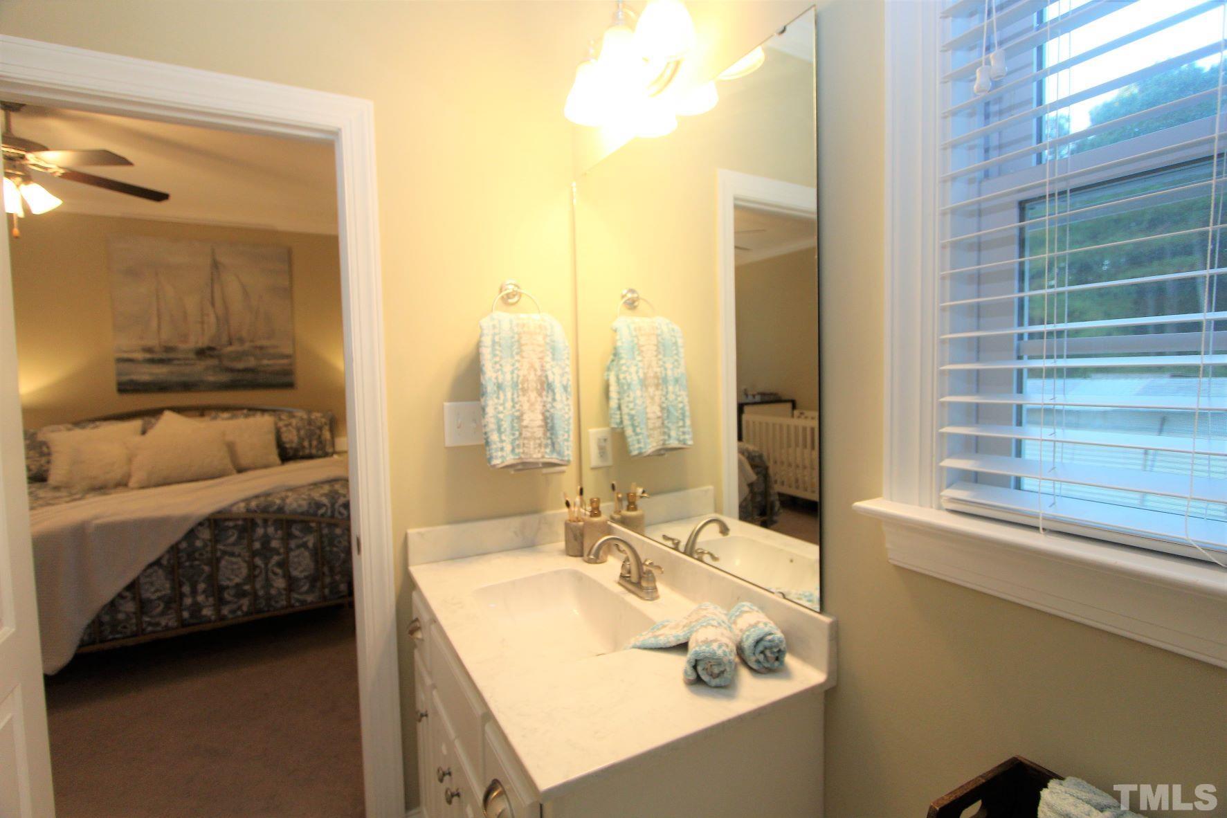 5436 Shepherd Road Wilson, NC 27893 - Photo 22 of 28 a en suite bathroom with a granite countertop tub and a sink