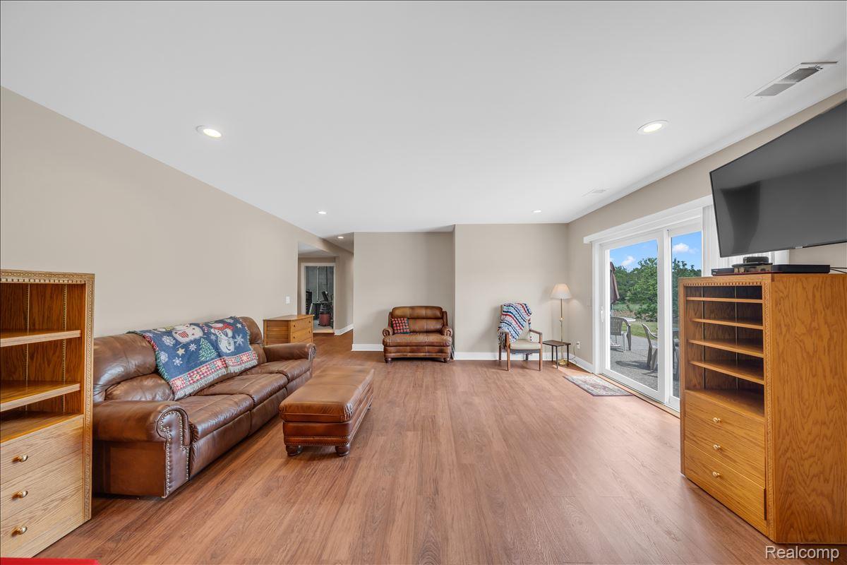 4266 McCandlish Road Grand Blanc, MI 48439 - Photo 44 of 68 Spacious living area featuring wood-finish flooring, recessed lighting, and light neutral wall tones