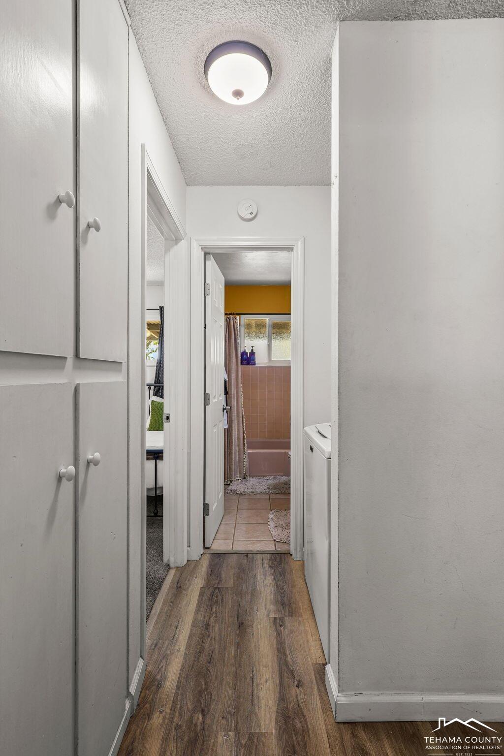 22275 Brent Road Red Bluff, CA 96080 - Photo 16 of 47 a view of a hallway with wooden floor and a bathroom