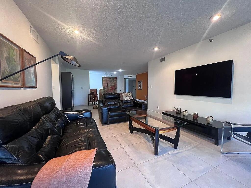 6463 La Costa Drive, Unit 105 Boca Raton, FL 33433 - Photo 13 of 40 a living room with furniture and a flat screen tv