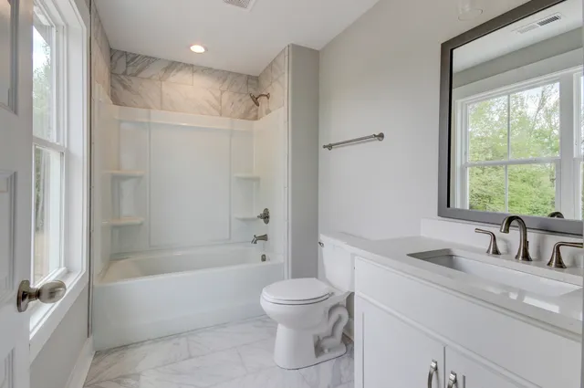 a bathroom with a sink toilet tub and shower