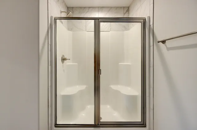 a bathroom with a glass shower door