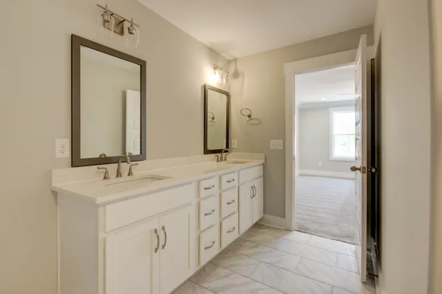 a bathroom with a double vanity sink and a mirror