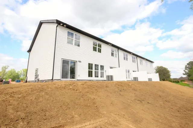 a front view of a house with a big yard