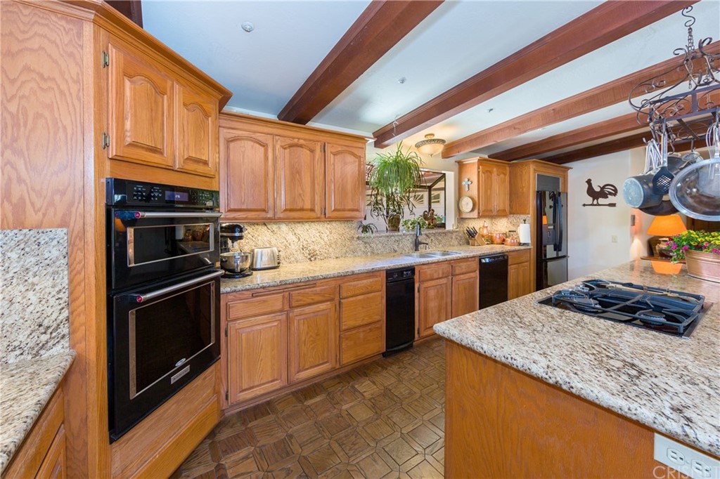 38833 Gorman Post Road Lebec, CA 93243 - Photo 14 of 55 a kitchen with stainless steel appliances granite countertop a sink stove and cabinets