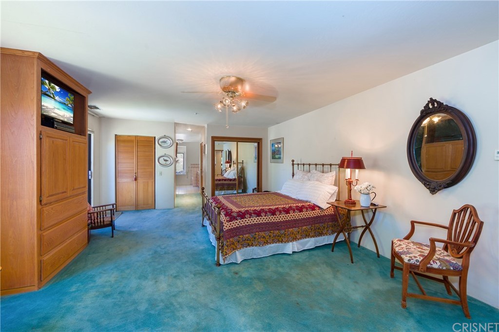 38833 Gorman Post Road Lebec, CA 93243 - Photo 23 of 55 a bedroom with a bed and a chair